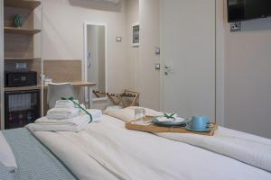 Postel nebo postele na pokoji v ubytování Gigli Rooms