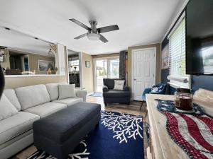 a living room with a couch and a ceiling fan at 34 Dillingham Avenue Sandwich Cape Cod - Aloha in Sandwich
