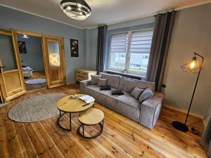 a living room with a couch and a table at Family Rooms in Zabrze