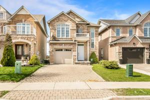 a house with a driveway in front of it at Pristine Pet & Smoke Free 4-Bedroom home near Canada's Wonderland in Vaughan