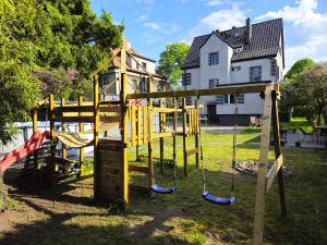 a playground in front of a house at Family Rooms in Zabrze