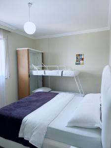 a hospital room with a bed and a bunk bed at 4 season Apartment in Lezhë
