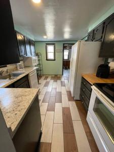 a kitchen with a large kitchen with a floor at Beautiful Trailside Haven on the Edge of Town in Hibbing