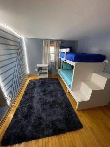 a room with a bunk bed and a rug at Beautiful Trailside Haven on the Edge of Town in Hibbing