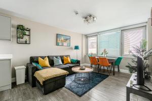 a living room with a couch and a table at Green Diamond by Creatick Apartments in Brighton & Hove
