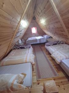 a room with four beds in a attic at Apartman Jegdic-Zabljak in Žabljak