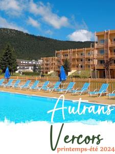 a group of lounge chairs next to a swimming pool at Appartement VERCORS 4 personnes in Autrans