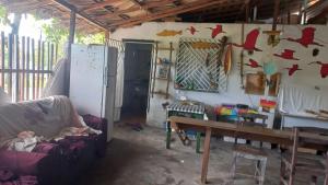 a living room with a couch and a table at Pousada Atins Melo in Atins