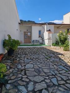 a stone patio in front of a house at CASA FLORIS in Tertenìa
