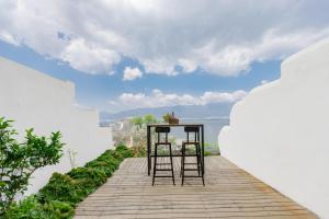 duas cadeiras sentadas num passadiço de madeira com vista para o oceano em Dali Dare Sea View Gueshouse em Dali