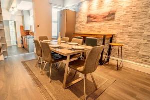 a dining room with a wooden table and chairs at Pass the Keys Stylish 5 bed near major companies in Nottingham