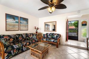 a living room with a couch and a table at Keauhou Kona Surf and Racquet Club Townhouse# 185 in Kailua-Kona