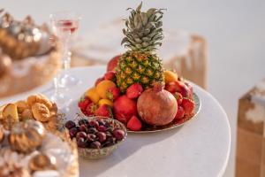 a plate of fruit on a white table at The Cycladic Pavilion Naxos in Galanado