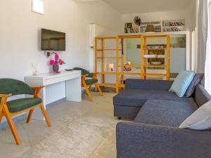 a living room with a couch and a desk at Oza Boutique hotel in Gümüşlük
