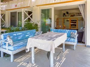two blue benches and a table on a patio at Oza Boutique hotel in Gümüşlük