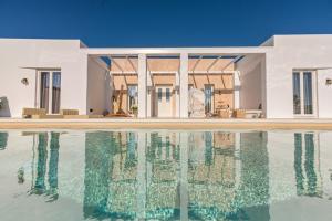 an external view of a house with a swimming pool at The Cycladic Pavilion Naxos in Galanado