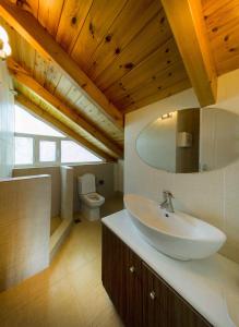 a bathroom with a sink and a toilet at Meliti Villa in Píla