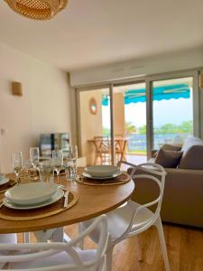 a dining room with a table and chairs with glasses at Bellissimo Appartamento Vistamare in Antibes +12 photos