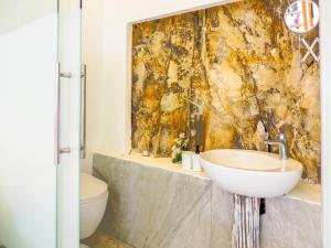 a bathroom with a sink and a toilet at Oza Boutique hotel in Gümüşlük