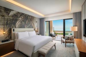 a bedroom with a bed and a living room at Conrad Rabat Arzana in Rabat +66 photos