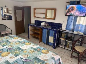 a room with a table and a blue tiled counter at Casa Luna A2 in Cozumel