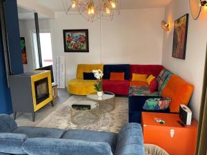 a living room with a couch and a tv at Belle Villa, piscine chauffée à 250m des plages in Biarritz
