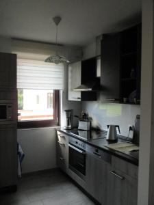 a kitchen with a sink and a stove top oven at Ferienwohnung im Herzen von Peitz in Peitz