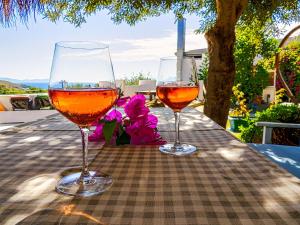 two glasses of wine sitting on a table at Oza Boutique hotel in Gümüşlük