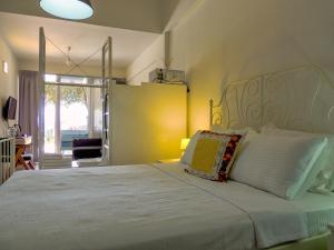a bedroom with a large white bed and a window at Oza Boutique hotel in Gümüşlük