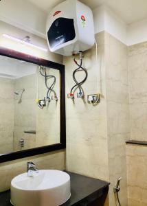 a bathroom with a sink and a mirror at RIGS Homestay in Gangtok