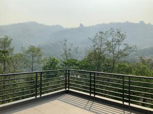 a balcony with a view of a valley at RIGS Homestay in Gangtok