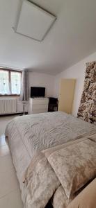 a white bedroom with a large bed in it at Rifugio collina del Sacro Cuore in Ascoli Piceno