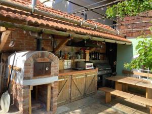 an outdoor kitchen with a brick oven and a grill at Schreiner in Wernstein am Inn