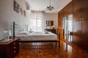 a bedroom with a bed and a dresser at Valmara Aretina House in Firenze in Florence