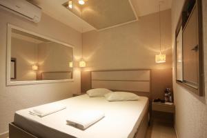 Ένα ή περισσότερα κρεβάτια σε δωμάτιο στο Hotel Coqueiros