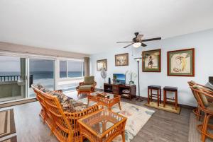 a living room with a view of the ocean at Banyan Tree 404D in Kailua-Kona