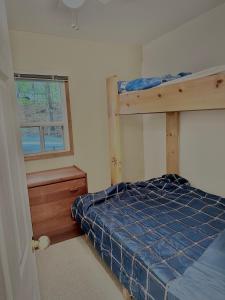 een slaapkamer met een stapelbed en een raam bij Great Escape! (WATERFRONT Cottage in Muskoka) in Windermere