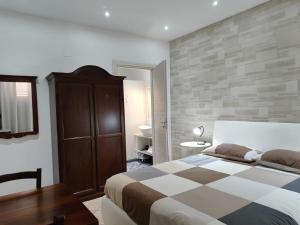 a bedroom with a king sized bed and a table at Bed and Breakfast Alberini in Noto