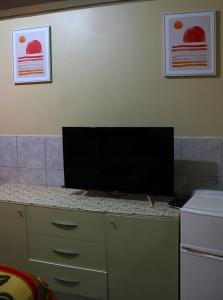 a computer monitor sitting on top of a counter at Caribbean Tourist Villa in Port-of-Spain