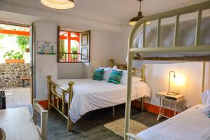 a bedroom with two bunk beds and a window at Finca La Manchuria in Salgar +131 photos