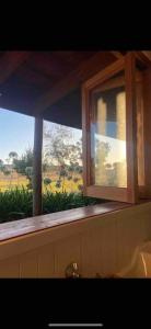 a window in a bathroom with a view of a field at Rustic Retreat: The Lodge Lurg Sanctuary in Upper Lurg