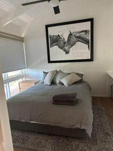 a bedroom with a bed and a picture on the wall at Rustic Retreat: The Lodge Lurg Sanctuary in Upper Lurg