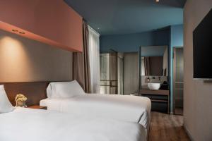 una camera d'albergo con due letti e un bagno di Garden Suites a Roma