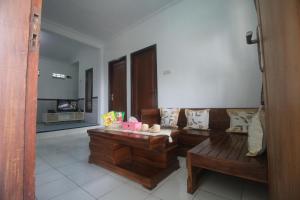a living room with a couch and a table at Griya Indah Homestay in Pacet
