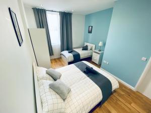 1 dormitorio con cama y sofá en 2 Bed Flat - 2 Bath - 15 min Camden Town en Londres