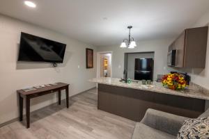 a living room with a kitchen with a counter at Lock Haven Grandview Hotel in Mill Hall