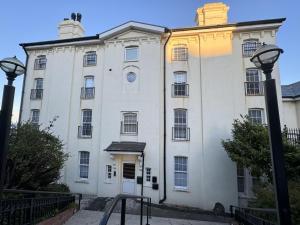 a large white building with a street light in front at Beautiful 1-Bed Apartment in Walton on the Naze in Walton-on-the-Naze