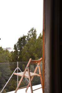 a wooden chair sitting on top of a balcony at Camping Fonts del Algar in Callosa d'en Sarrià