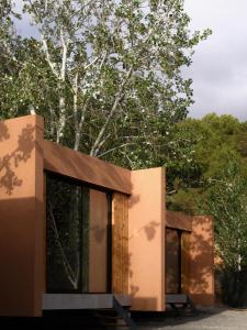 a rendering of a building with a tree in the background at Camping Fonts del Algar in Callosa d'en Sarrià