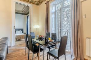 AB Bruc City Center في برشلونة: غرفة طعام مع طاولة وكراسي